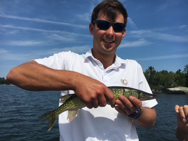 Guide holding a large bass from the canoe
