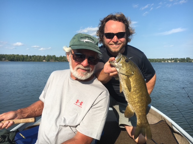 Angler with a smallmouth bass from the canoe
