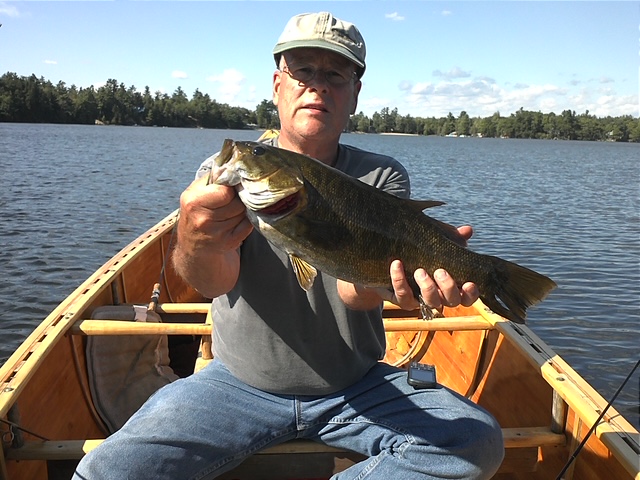 Large smallmouth bass held above the water