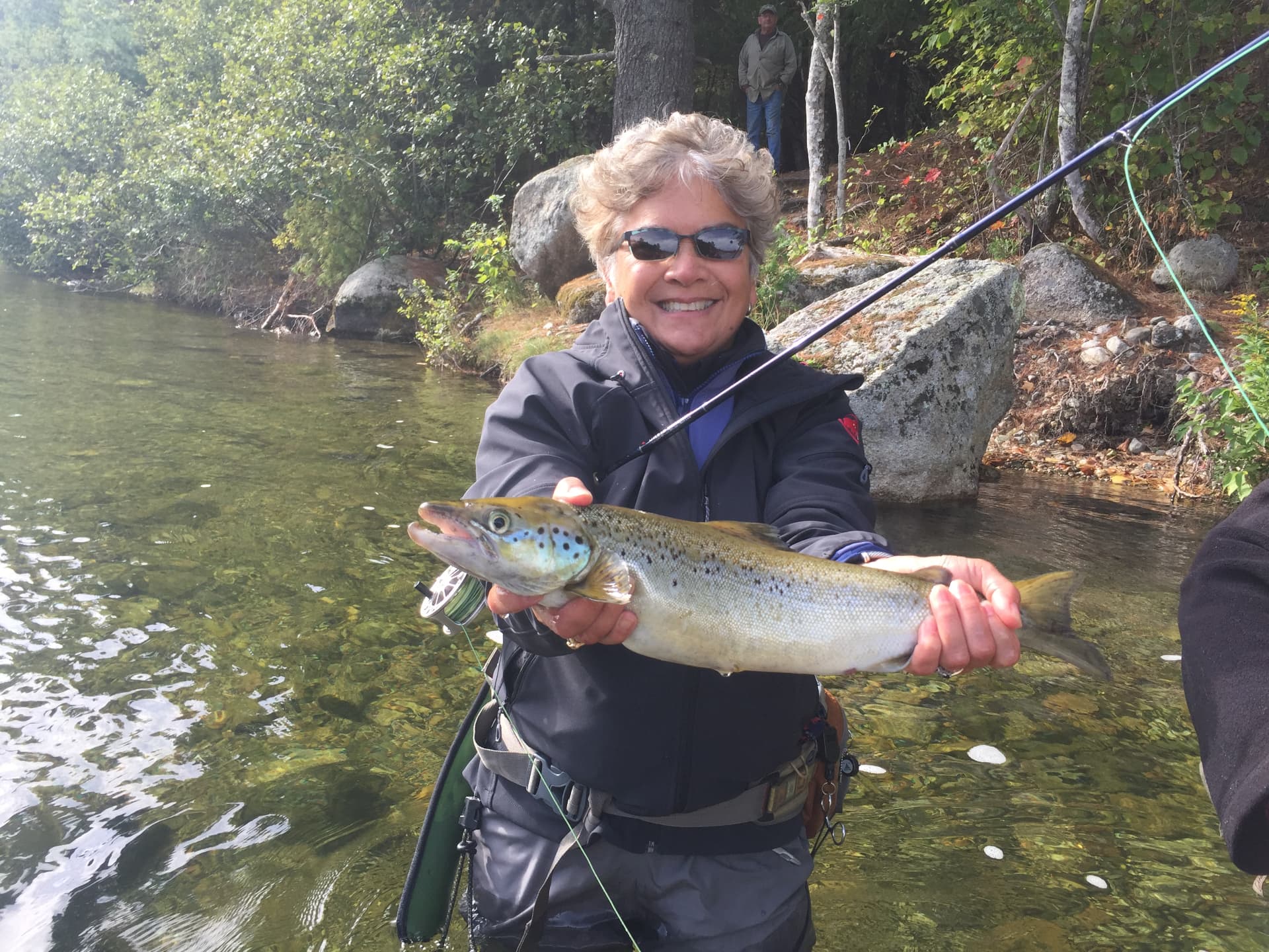 Angler with a large landlocked salmon on Grand Lake Stream